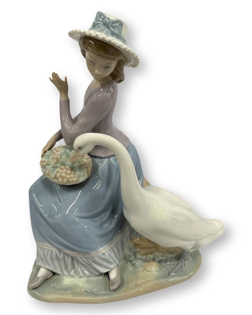 Lladro #5034 Goose Trying to Eat Porcelain Figurines: Lladro #5034 Goose Trying to Eat Porcelain Figurines measures H: 9 1/2"