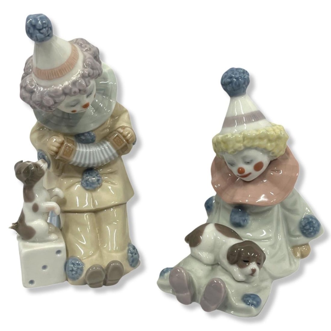 Pair of Lladro Porcelain Figurines: Pair of Lladro Porcelain Figurines includes #5279 pierrot with concertina & #5277 pierrot with puppy. Largest measures H: 5 3/4"