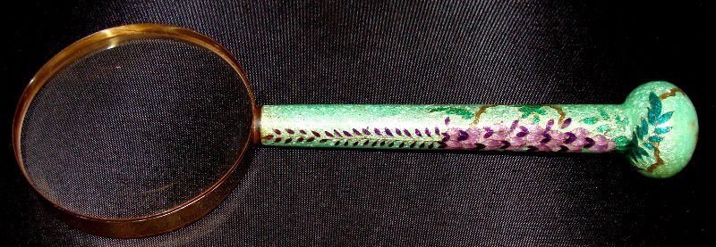 Japanese Cloisonne Handled Magnifying Glass: Japanese Cloisonne Handled Magnifying glass with flower and leaf decoration. Measures 9 7/8" long. For Domestic or International Shipping Quotes Please Feel Call Ryan or Dave at Eagle Shipping Center 