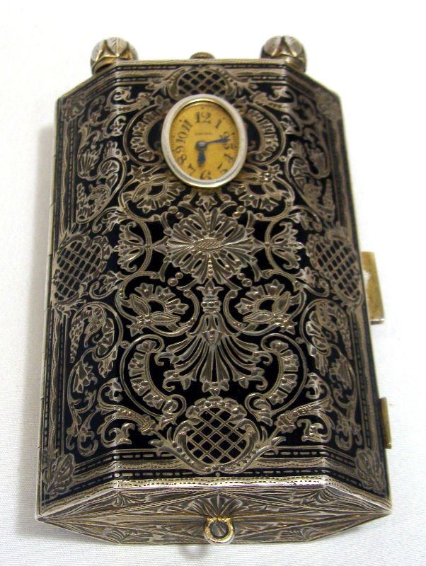 Antique Art Deco Austrian Sterling Silver Compact: Antique Austrian art deco sterling silver enamel compact hinged body with very elaborate black enamel and chased floral designes on the outside and gold wiashed interior with mirror, powder puff, ciga