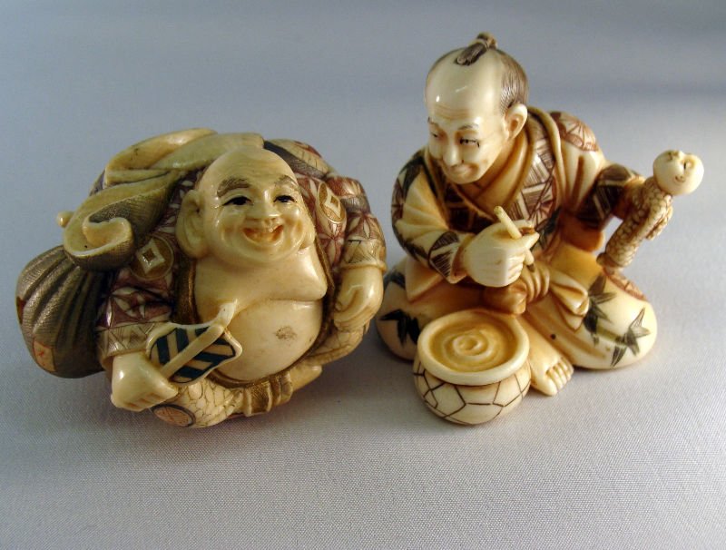 2 Chinese Ivory Netsuke: 2 Chinese ivory polychrome Netsuke figures. One figure depicts a double Buddha and the other is painting a doll. Measures 1". For Domestic or International Shipping Quotes Please Feel Call Ryan or Dav