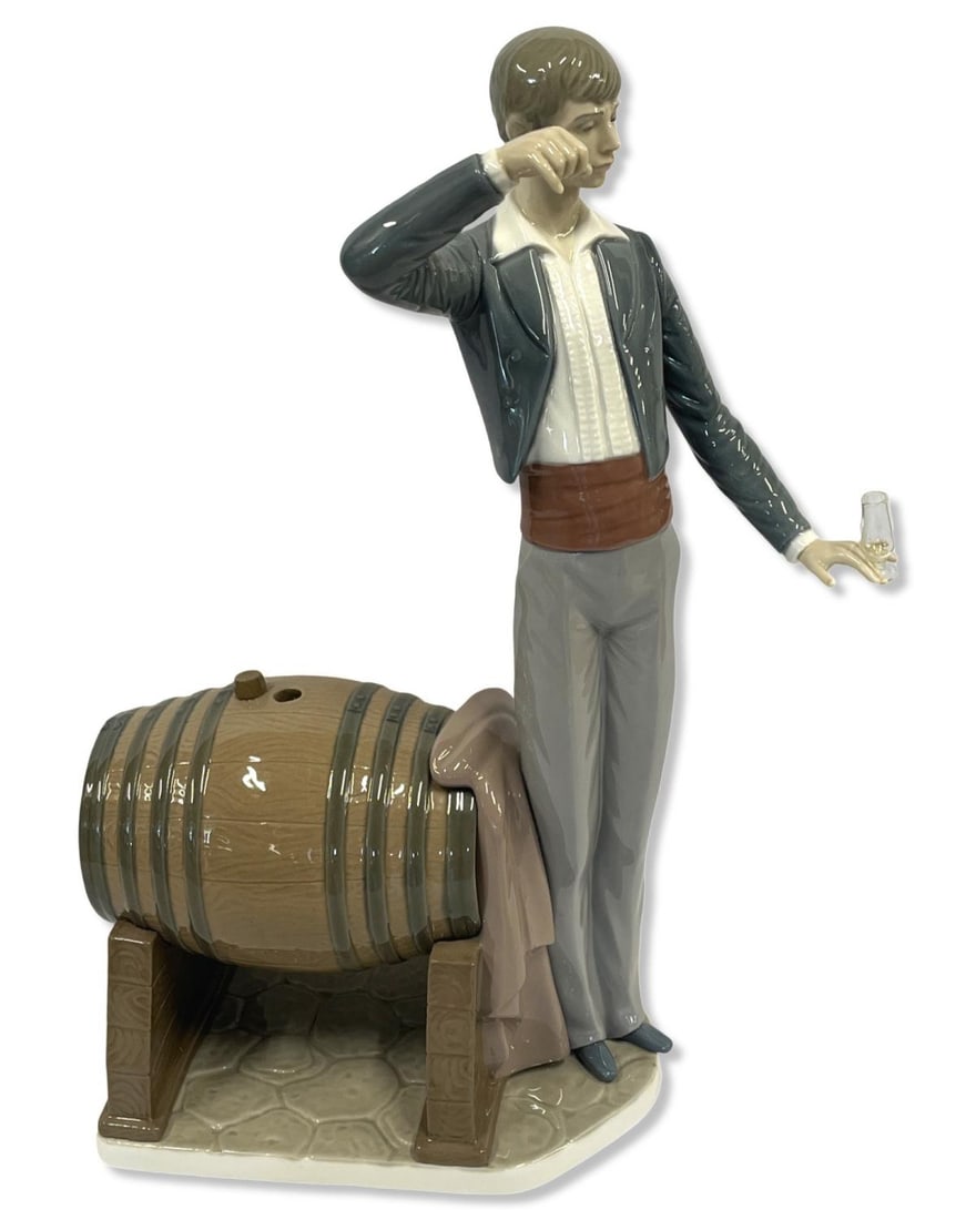 Lladro #5239 Wine Taster Porcelain Figure: Lladro #5239 Wine Taster Porcelain Figure measures H: 14 1/4". Has damage on right hand, sold as is