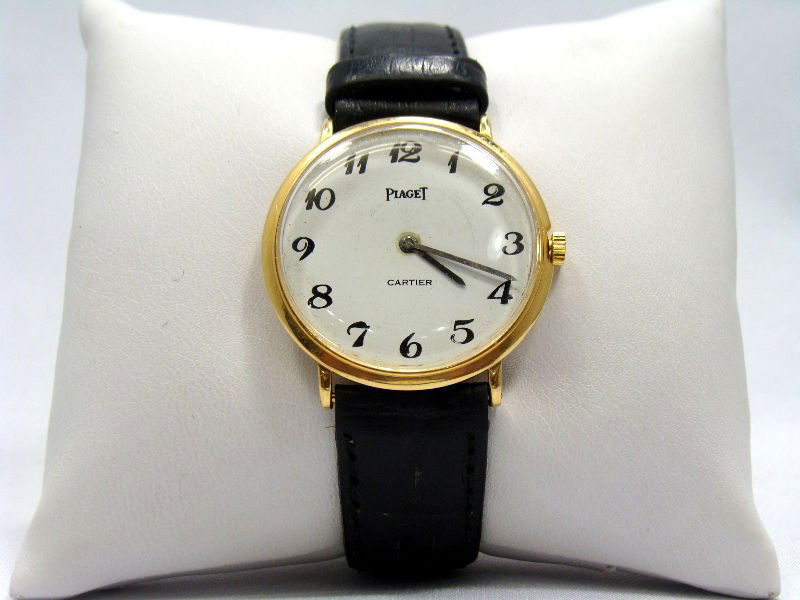 Piaget 18kt Yellow Gold Wristwatch: Piaget 18kt yellow gold wristwatch retailed by Cartier, the dial has Arabic numerals. Case NO. 109299For Domestic or International Shipping Quotes Please Feel Call Ryan or Dave at Eagle Shipping Cente