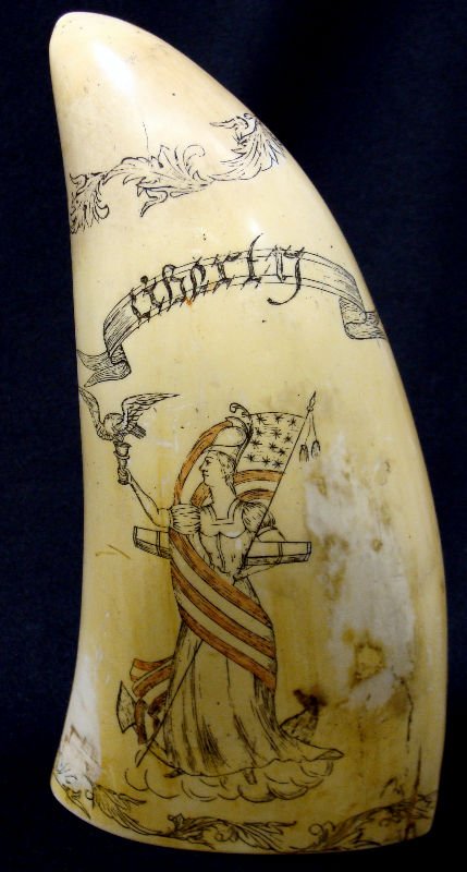 Scrimshaw Ivory Whale Tooth: Scrimshaw ivory whale tooth depicting the "Liberty" figure on one side and two ships on the other side titled Peacock and L.Epervere. Measures 6 1/2" high x 3 1/4" wide. For Domestic or International 