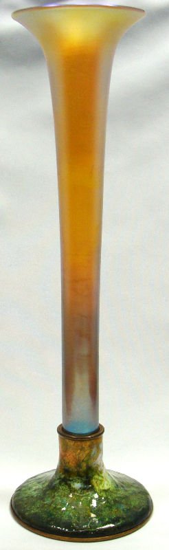 Tiffany Furnaces Favrile Glass & Enamel Vase: Tiffany furnaces Favrile glass and enamel vase with slender stem and flared rim raised on a greenish enamel base, signed Louis C. Tiffany Furnaces Inc.151. Measures 13" high. For Domestic or Internati
