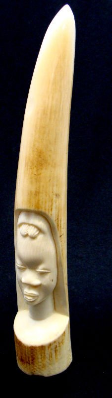 African Carved Ivory Figural Tusk: African carved ivory figural tusk. Measures 9 1/2" long. For Domestic or International Shipping Quotes Please Feel Call Ryan or Dave at Eagle Shipping Center 561-932-0700 or email them at ryan@eaglesh