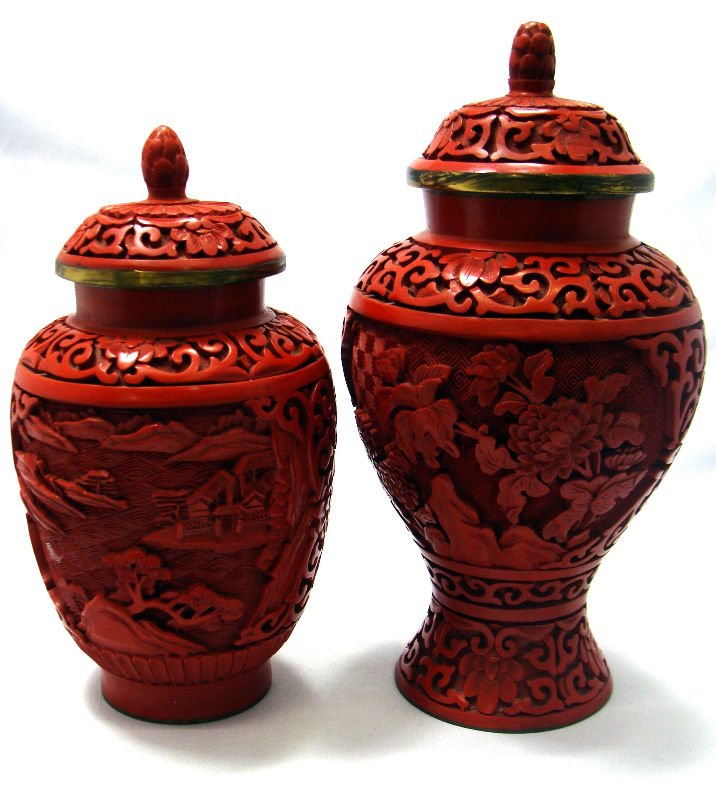 Cinnabar Covered Jars (2): Two cinnabar covered jars. Featuring floral motif. Measures 7" high x 3 1/2" wide. 6" high x 3 1/2" wide. For Domestic or International Shipping Quotes Please Feel Call Ryan or Dave at Eagle Shipping