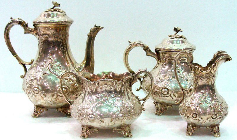 Antique 4pc Sterling English Tea Set: Antique four piece sterling silver English tea set comprising of creamer 6 1/8". Teapot 8". Coffee pot 10 1/2". Sugar 4 7/8". Total weight of 64.5 toz. For Domestic or International Shipping Quotes Pl