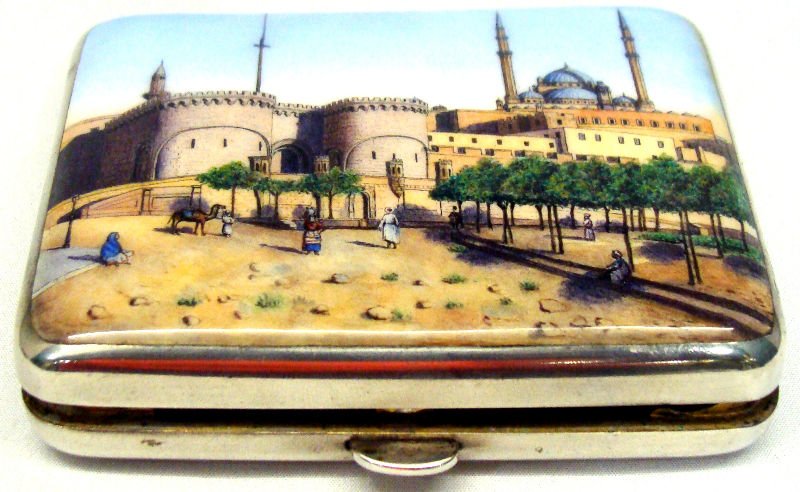 800 Silver Enamel Box: 800 silver enamel box depicts a Arabic landscape scene on one side and has a triple scroll monogram on the other side. Weighs 4toz. "800" hallmark on the inside. Measures 3 1/4" x 2 1/4" x 5/8". For D