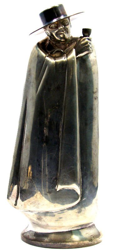 English Silver Lambert & Co. Mysterious Figure: English silver Lambert & Co. Herbert Charles Lambert London 1913 Hallmark. Figure of a mysterious man with a cloak and hat holding a drink in his hand. Measures 7 7/8' tall. Hallmarks on bottom H.L, L