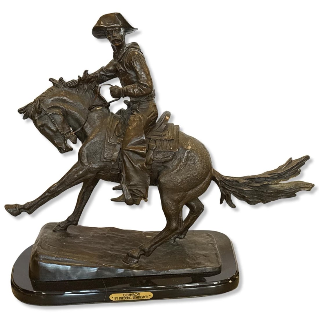 After Frederic Remington (American, 1861-1909) Bronze Sculpture on Marble Base Cowboy: After Frederic Remington (American, 1861-1909) Bronze Sculpture on Marble Base Cowboy measures H: 23" x W: 26" x L: 10"