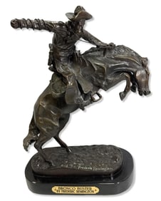 After Frederic Remington (American, 1861-1909) Bronze Sculpture on Black Marble Base Bronco Buster