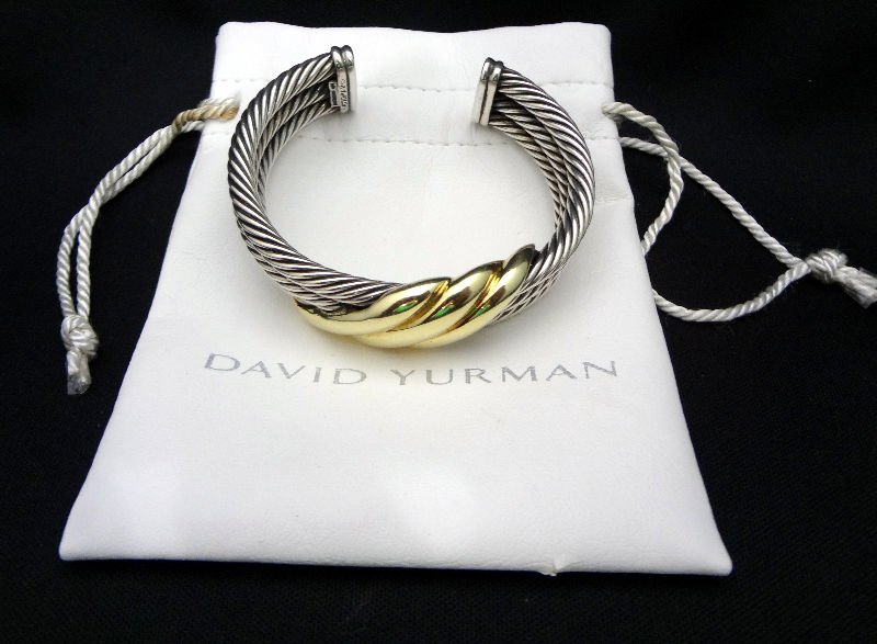 David Yurman Sterling Silver & 14 Kt. Y.G. Bracelet: Classic David Yurman Sterling Silver & 14 Kt. Y.G. Bracelet with cable design and 14 Kt. Yellow gold swirl on front. Retail value - $1600.00, Weighs - 1.57 ozt.For Domestic or International Shipping Q