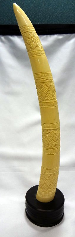 African Carved Ivory Tusk: African Carved Ivory Tusk. On round wood base. Measures - For Domestic or International Shipping Quotes Please Feel Call Ryan or Dave at Eagle Shipping Center 561-932-0700 or email them at ryan@eagles