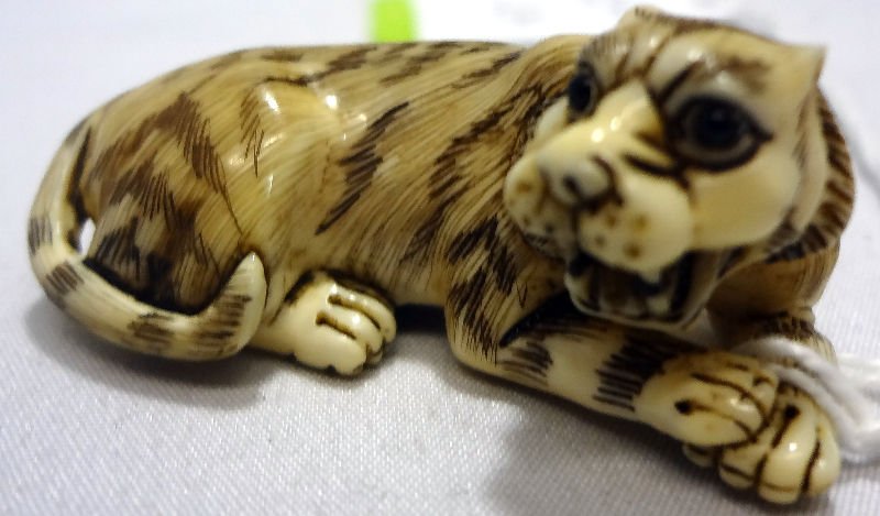 Chinese Ivory Tiger Netsuke: Chinese Ivory Tiger Netsuke. Measures 3/4" high.For Domestic or International Shipping Quotes Please Feel Call Ryan or Dave at Eagle Shipping Center 561-932-0700 or email them at ryan@eagleshippingcen