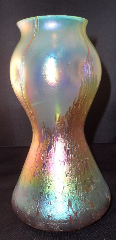 Loetz Iridescent Art Glass Vase: Loetz Iridescent art glass vase, yellowish hue, unsigned. Measures - Height - 8 1/4", Width - 4 1/2".For Domestic or International Shipping Quotes Please Feel Call Ryan or Dave at Eagle Shipping Cente