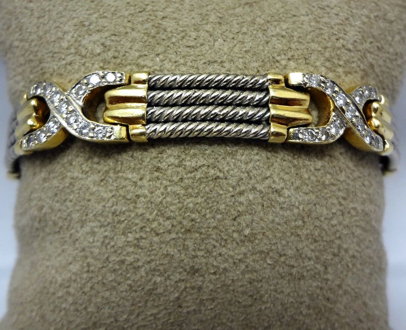 Fine Contemporary Phillipe Charriol Style Diamond Brace: Fine contemporary Phillipe Charriol style diamond bracelet featuring a sectional semi-ridged two tone design, twisted rope links bridged with diamond spacers, 52 round brilliant cut diamonds weighing
