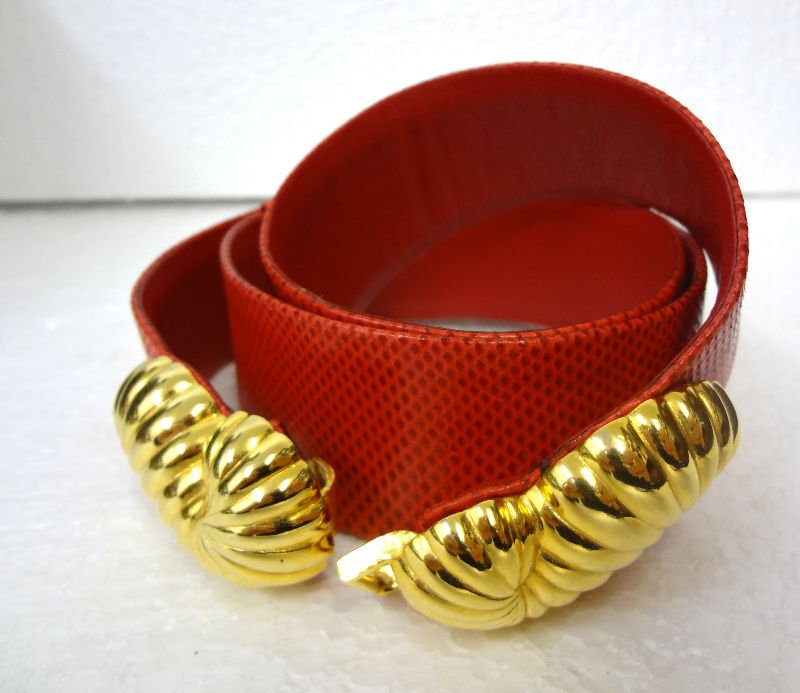 Judith Leiber Contoured Belt: Judith Leiber Contoured Belt. Red lizard skin belt with fashioned gold buckles. Label stamped Judith Leiber. Measures 34 1/2" long.For Domestic or International Shipping Quotes Please Feel Call Ryan o