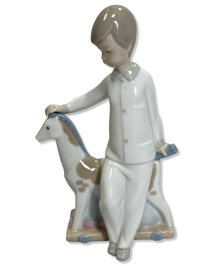 Lladro NAO Boy with Rocking Horse Porcelain Figurine: Lladro NAO Boy with Rocking Horse Porcelain Figurine measures H: 7 3/4" x W: 4 1/2"