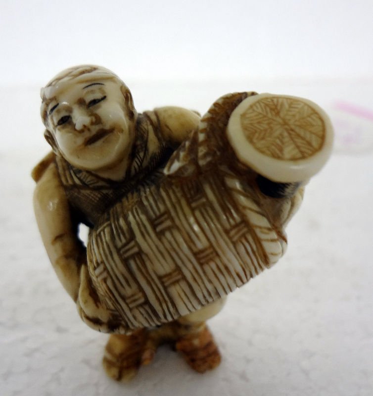 Chinese Carved Ivory Netsuke Figure with Basket: Chinese Carved Ivory Netsuke Figure with Basket. Measures - 1 3/4" high.For Domestic or International Shipping Quotes Please Feel Call Ryan or Dave at Eagle Shipping Center 561-932-0700 or email them 