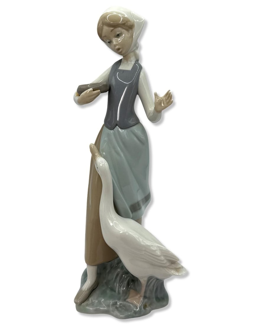 Lladro 1052 Girl with Duck Porcelain Figurine: Lladro 1052 Girl with Duck Porcelain Figurine measures H: 9 1/2" x W: 3 3/4"