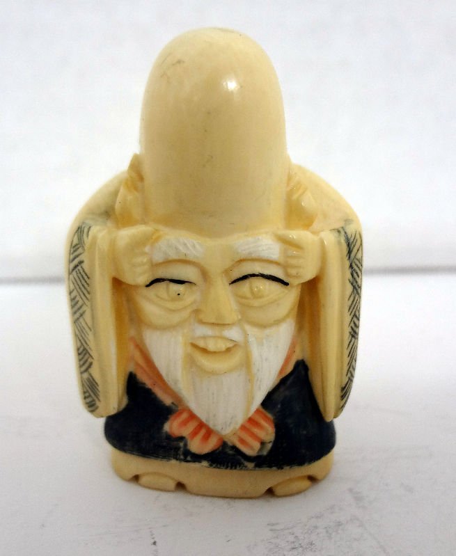 Polychrome Ivory Netsuke of Man with Big Face: Polychrome Ivory Netsuke of Man with Big Face. Measures - 2" high. For Domestic or International Shipping Quotes Please Feel Call Ryan or Dave at Eagle Shipping Center 561-932-0700 or email them at ry