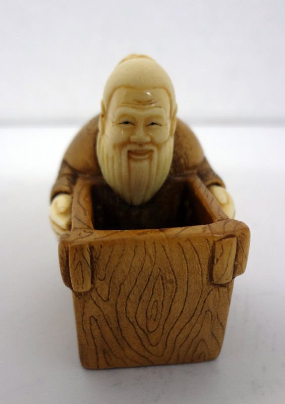 Rare Chinese Ivory & Wood Handcarved Netsuke: Rare Chinese Ivory & Wood Handcarved Netsuke. Depicting a man holding box. Measures - 2" high. For Domestic or International Shipping Quotes Please Feel Call Ryan or Dave at Eagle Shipping Center 561-
