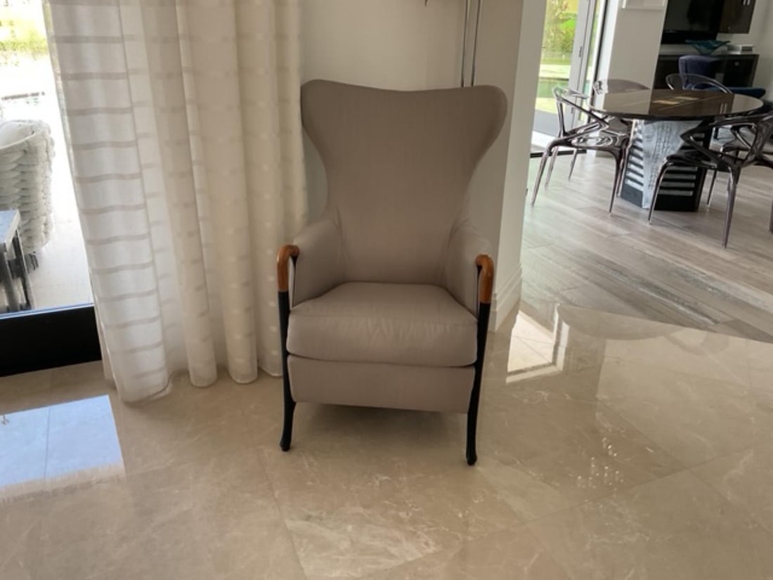 Beige Tone Upholstered Chair with Black and Wood Accents: Beige Tone Upholstered Chair with Black and Wood Accents. Original retail price of $4,120.00