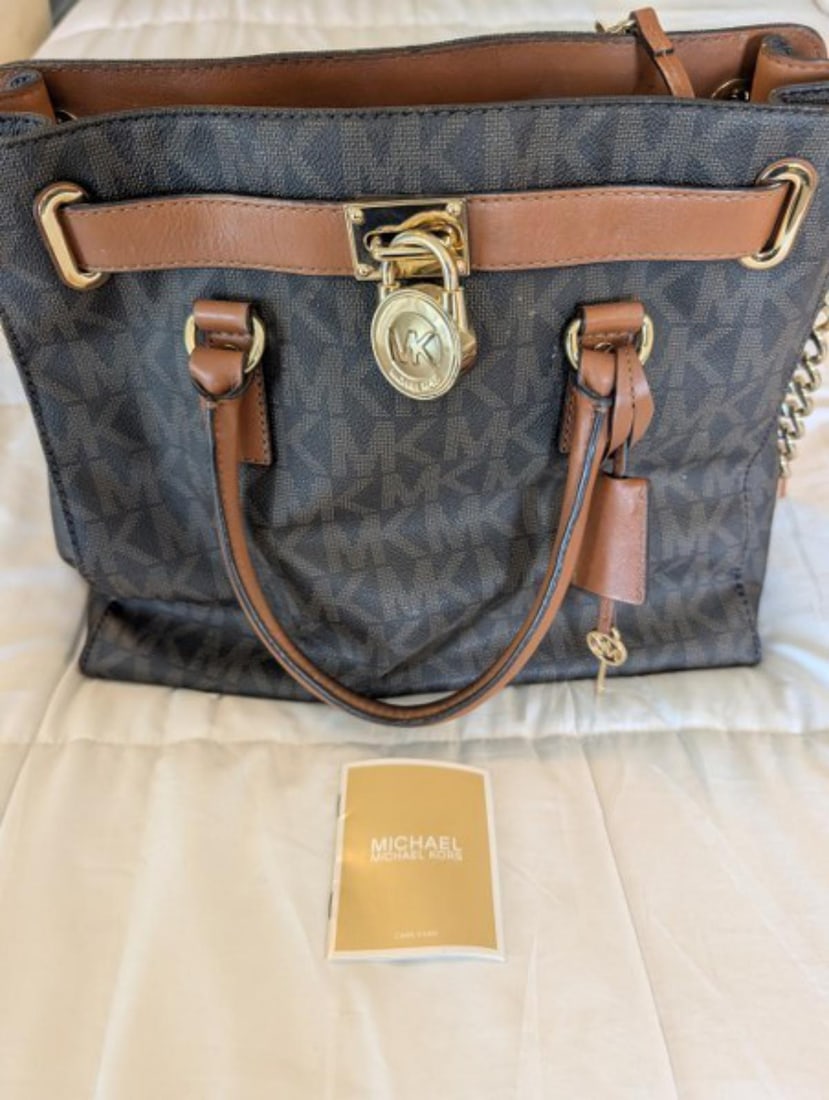 Authentic Michael Kors Signature Monogram Tote Handbag with Gold-Tone Hardware: Authentic Michael Kors signature monogram tote handbag featuring the classic MK logo canvas, rich brown leather trim, dual carry handles, detachable shoulder strap, and polished gold-tone hardware, in