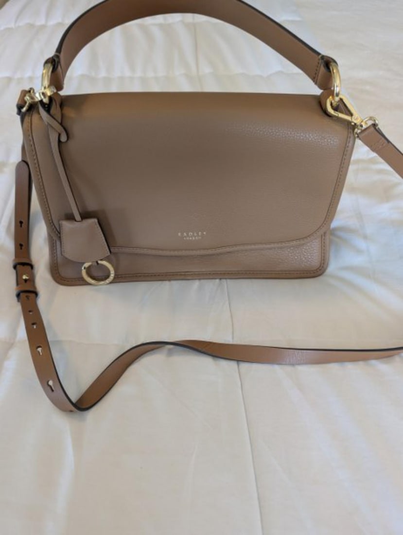 Radley London Taupe Leather Handbag with Shoulder Strap and Dust Bag: Elegant Radley London taupe leather handbag featuring a structured silhouette, top carry handle, removable and adjustable shoulder strap, gold-tone hardware, and signature Radley London detailing thro
