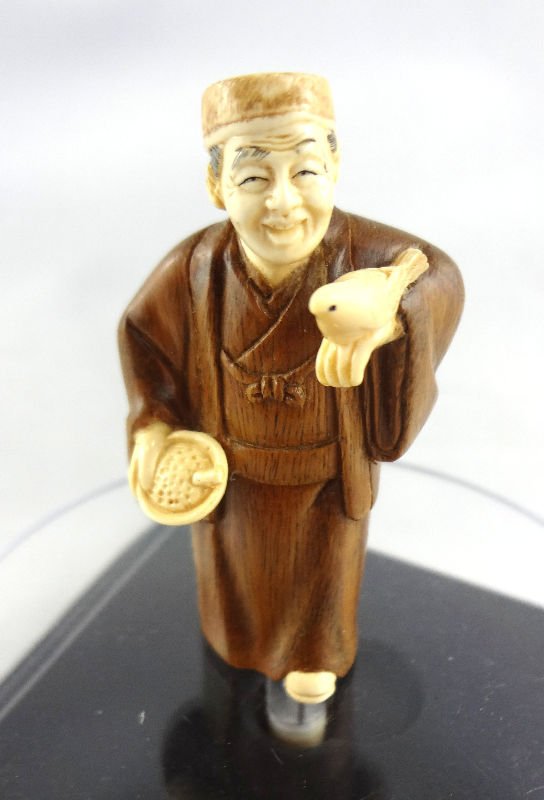 Chinese Hand Carved Ivory Netsuke: Chinese Hand Carved Ivory & Stained Netsuke. Depicting man with bird, mother of pearl mark. For Domestic or International Shipping Quotes Please Feel Call Ryan or Dave at Eagle Shipping Center 561-932