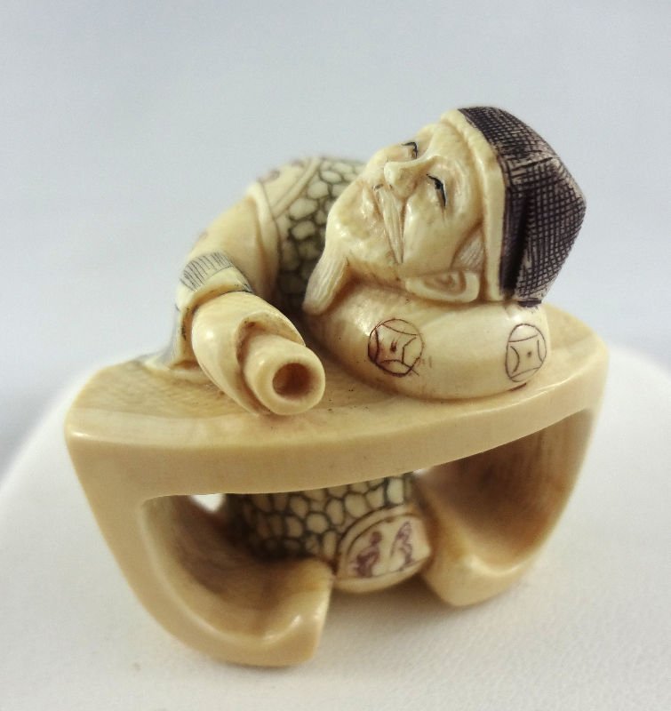 Chinese Hand Carved Ivory Netsuke: Chinese Hand Carved Ivory Netsuke of man sleeping on desk.