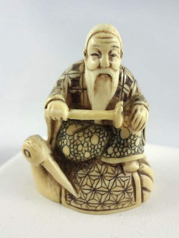 Chinese Hand Carved Ivory Netsuke: Chinese Hand Carved Ivory Netsuke man on top of bird.