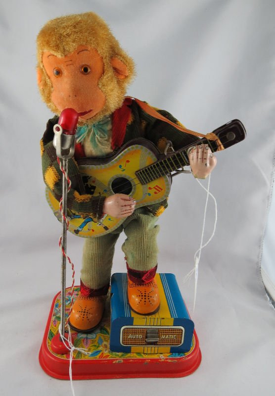 Antique Monkey Playing Guitar On Stage Toy: Antique Monkey Playing Guitar On Stage Toy. Measures - 12" high x 6 1/4" wide.