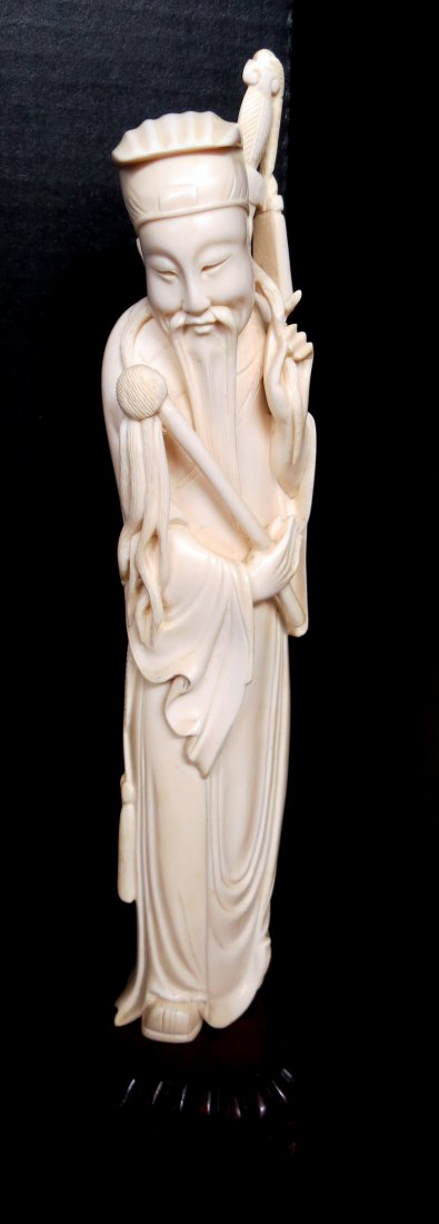 Antique Chinese Hand Carved Ivory Figure: Antique Chinese Hand Carved Ivory Figure. Depicting a man with weapons. Measures - 10 7/8" high, base - 1/2".