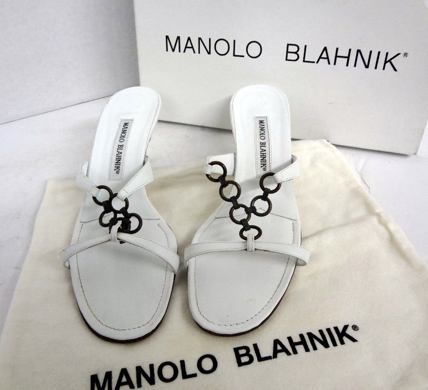 Manolo Blahnick White Calf Leather Sandals: Manolo Blahnick White Calf Leather Sandals with metal ring design. Made in Italy. Retail value - $515.00. Size 38. Original pouch and box. Condition - gently worn.