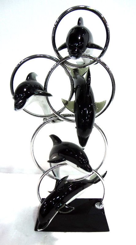 Murano Glass Dolphin Sculpture: Italian Murano glass five figural dolphins jumping through hoops on black glass base. Measures 27 1/2" tall.
