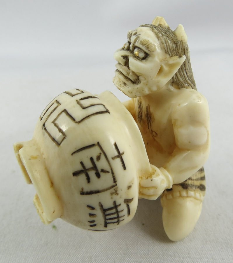 Antique Chinese Hand Carved Ivory Netsuke Group: Antique Chinese Hand Carved Ivory Netsuke Group depicting a monster carrying a pot and signed. Measures - 2".