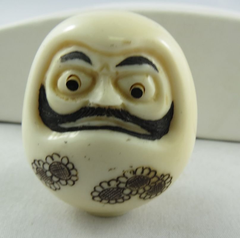 Antique Chinese Hand Carved Ivory Netsuke: Antique Chinese Hand Carved Ivory Netsuke, figure with eyes bolding. Measures - 1 1/2" high.