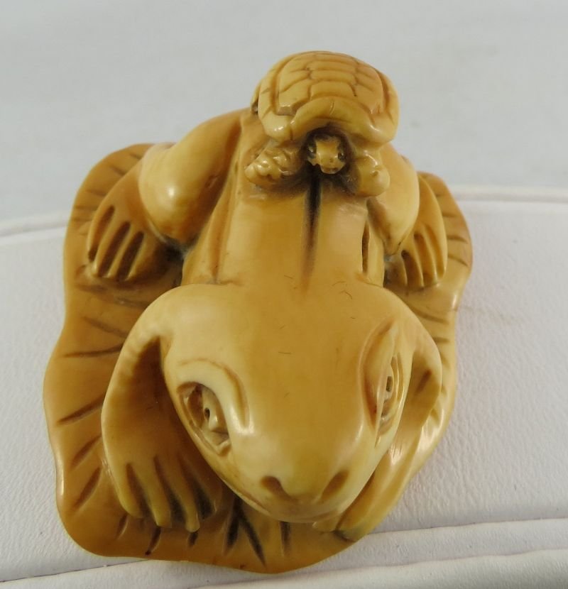 Antique Chinese Hand Carved Ivory Netsuke: Antique Chinese Hand Carved Ivory Netsuke, depicting frog on leaf, turtle on frog. Measures - 1 7/8" wide.