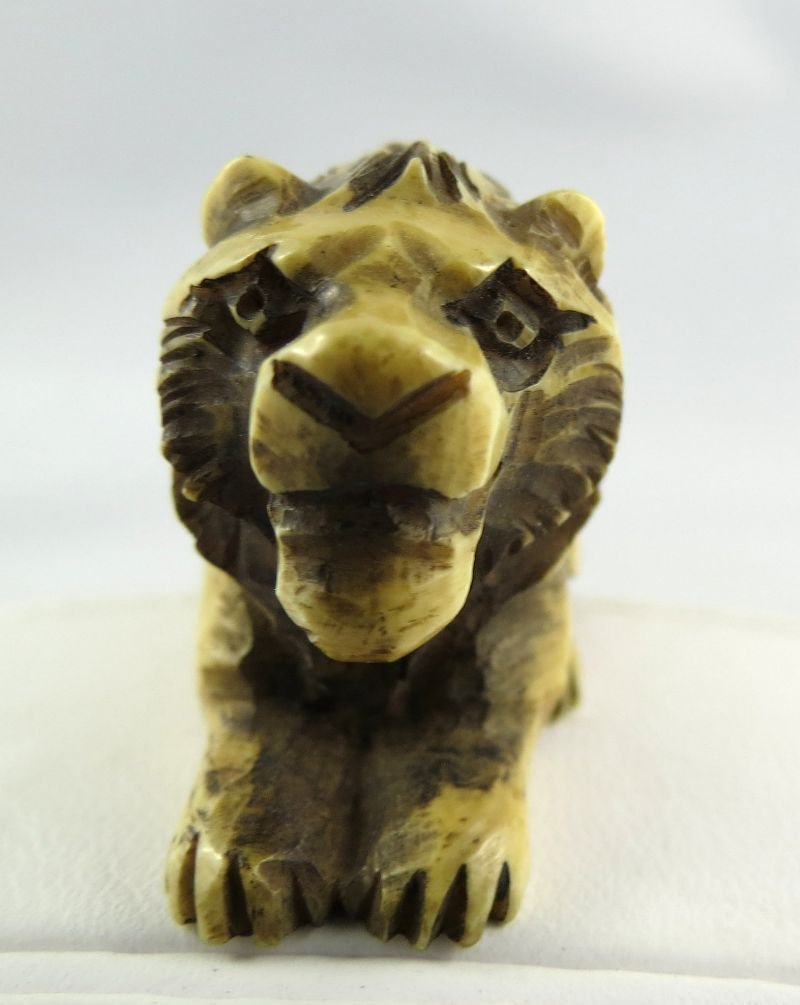 Chinese Hand Carved Ivory Netsuke: Chinese Hand Carved Ivory Netsuke, depicting lion figure. Measures - 2" wide.