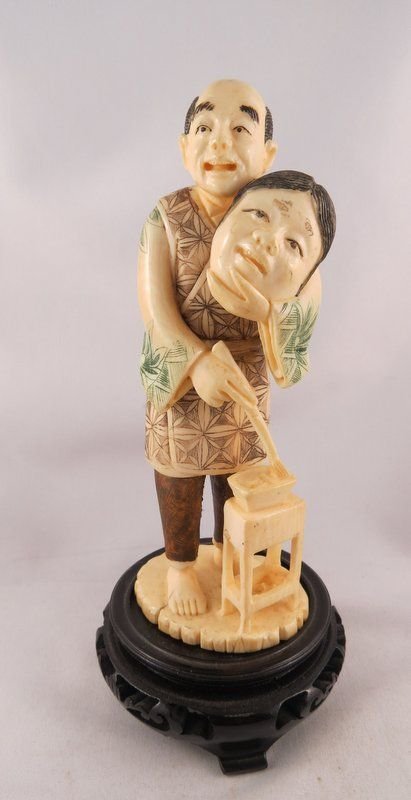 Antique Finely Carved Ivory Japanese Figure: Antique Finely Carved Ivory Japanese Figure featuring a man painting a mask, marking on bottom. Measures - ivory - 6 1/4" high x 2 1/4" wide, ivory with base - 7 1/4" high.