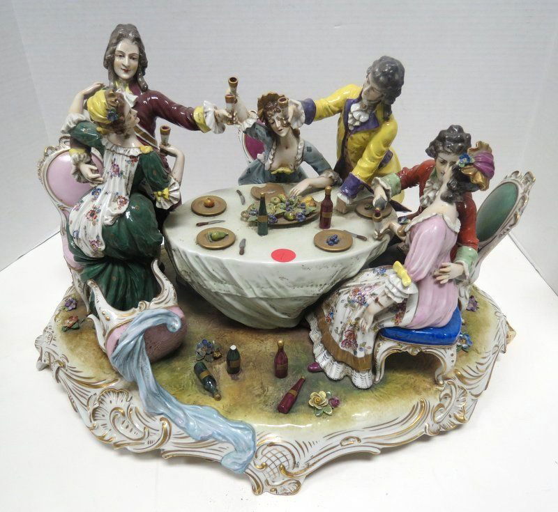 Capodimonte Porcelain Group of Figures: Capodimonte Porcelain Group of Figures. Depicting three couples of figures at a table eating and drinking. Measures 12" high x 19 1/2" wide.