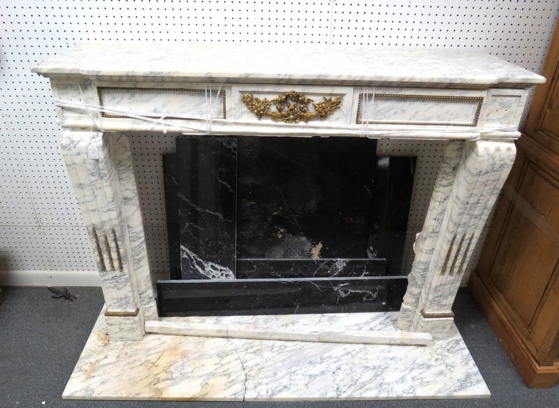 19th C. White Marble Fireplace Surround: 19th C. White Marble Fireplace Surround. This fireplace is a masterful display of marble and bronze design. Missing minor bronze mounting. Measures - 52 1/2" high x 54 1/2" wide x 15" deep.