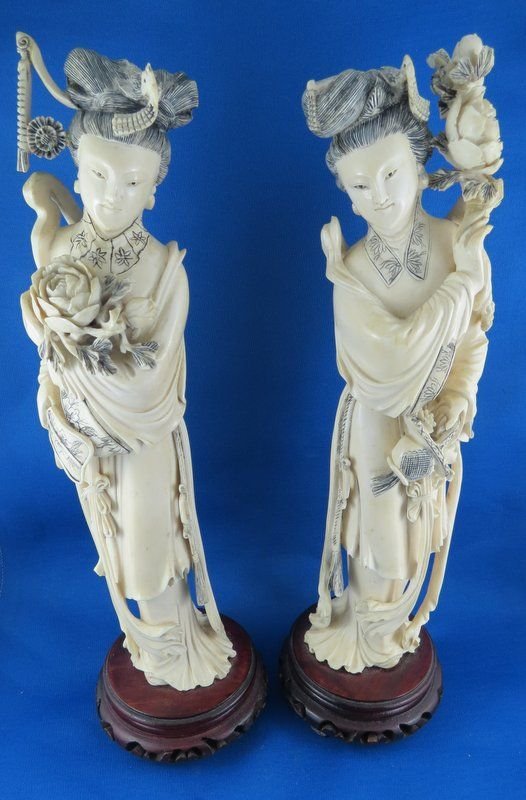 Very Fine 20th C. Carved Ivory Geisha Figurines: Very Fine 20th C. Carved Ivory Geisha Figurines. 13 1/8" featuring a intricate curved hand carved design of a Geisha holding a floral bouquet and mirror, signed on the bottom with the master hallmark 