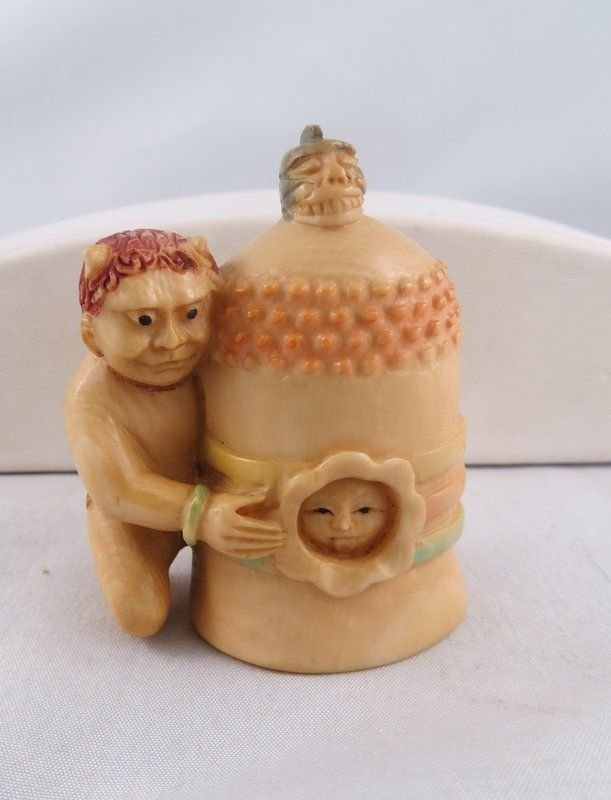 Chinese Hand Carved Ivory Netsuke: Chinese Hand Carved Ivory Netsuke featuring demon holding a bell, very unusual. Measures - 2" high.
