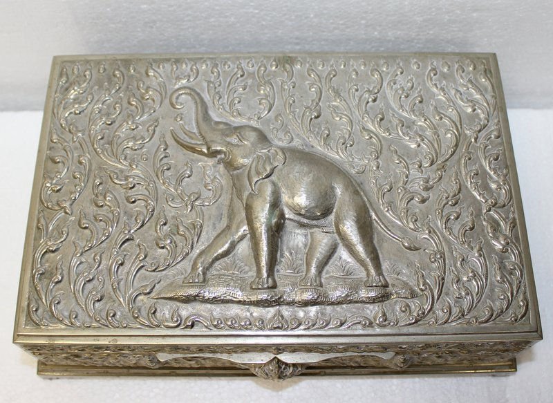 Thailand Silver Box w/ Wood Insert: Thailand Silver Box w/ Wood Insert. The exterior of the box is decorated with repousse scroll work and a large image of a elephant. Measures - 3 1/2" x 10" x 6 1/2".