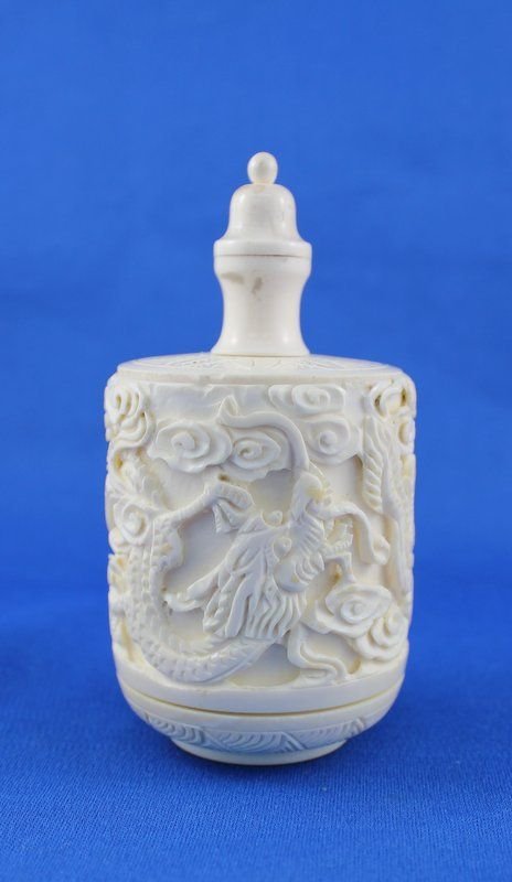Finely Carved Ivory Covered Jar: Finely Carved Ivory Covered Jar with dragon design, makers mark on the bottom. Measures - 4 1/8" high x 2 1/8" wide.