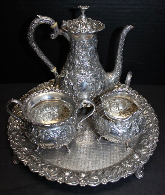 4 Pc. Sterling Silver Floral Repousse Tea Set: 4 Pc. Sterling Silver Floral Repousse Tea Set. Weighs - 58 ozt. Tea pot - 8 1/2" high x 7 1/4" wide, creamer - 3 3/4" high x 4 5/8" wide, sugar - 3 1/4" high x 5 1/2" wide, tray - 11 1/8" diameter.