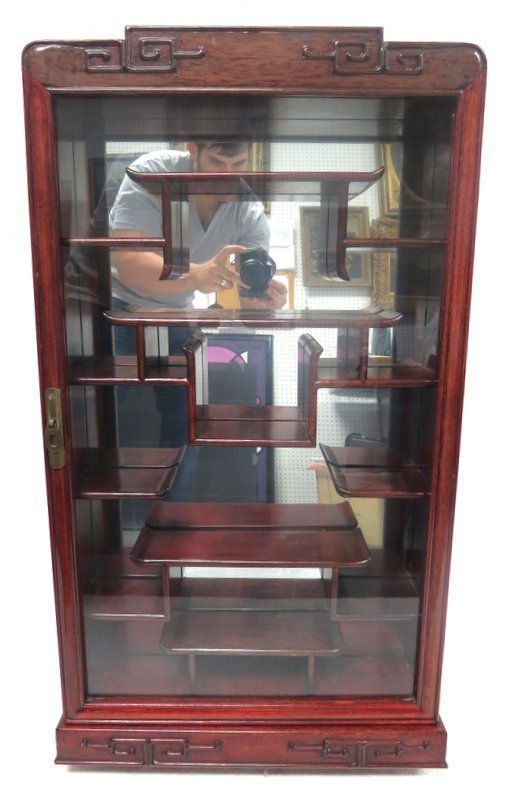 Oriental Carved Rosewood Netsuke Cabinet: Oriental Carved Rosewood Netsuke Cabinet having a full glass door with multiple shelves for display purposes. Measures - 32 1/2" x 18" x 5".